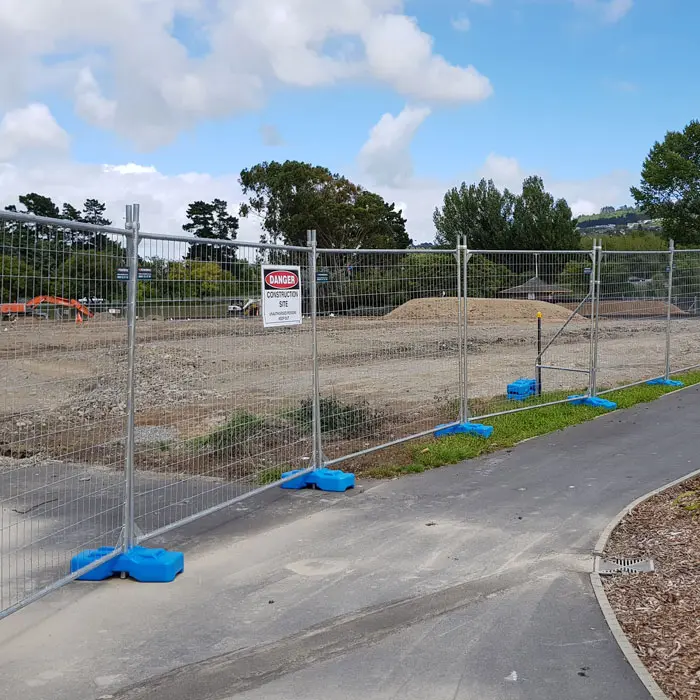 2.4m Temporary fence panel set up on a construction site with fence brace and blue plastic fencing feet