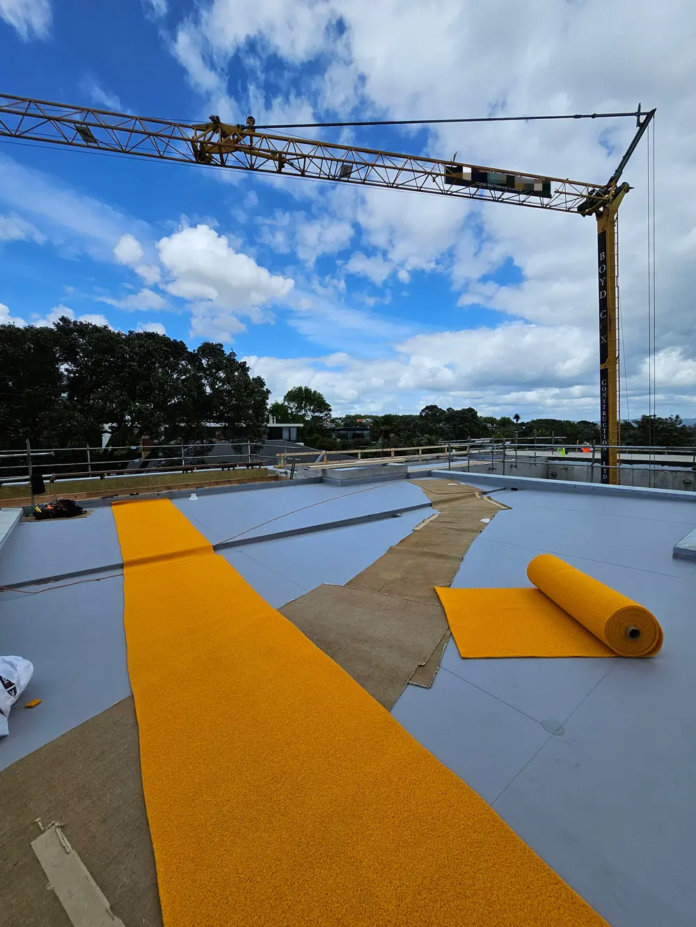 safe path matting on a construction site with a crane in the background