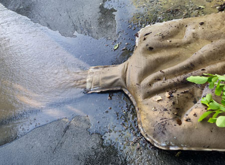 Water coming out of dewatering bag after hose has been removed