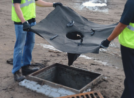 Drain guard held over a drain