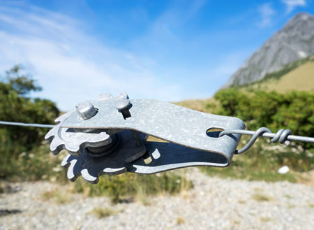 Wire strainer in a rocky mountain landscape attached to a fence
