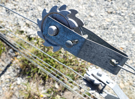 Wire strainer attached to a wire fence on a farm